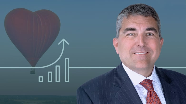 Joe Maier headshot over an ariel image of a hot air balloon.